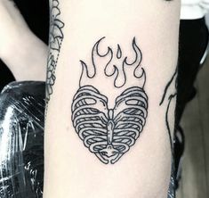 a black and white photo of a tattoo with flames on the back of his arm