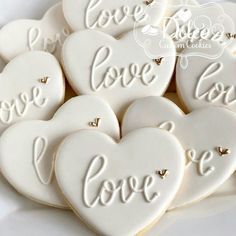 heart shaped cookies with the words love on them