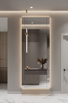 the interior of a modern apartment with marble flooring and white walls, along with a large mirror on the wall