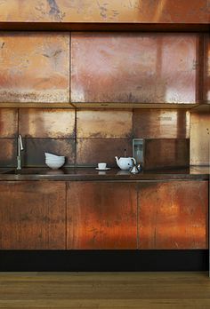 an old kitchen with rusted metal cabinets and counter tops is pictured in this image