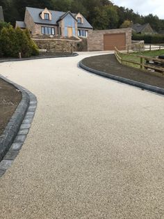 an empty driveway in front of some houses