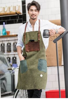 a man in an apron holding a coffee mug