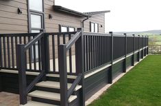 a black and white stair rail next to a house