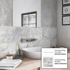 a bathroom with marble walls and white fixtures