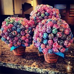 two vases filled with candy sitting on top of a counter next to each other