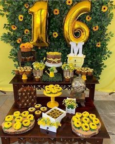 a table topped with lots of desserts and balloons