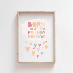 a framed print with the words born together friends forever in pink, yellow and green