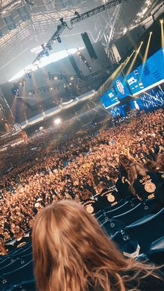 a large crowd at a concert in an arena