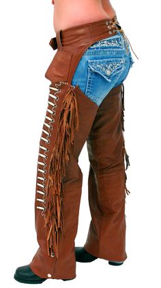 Cowboy chaps in brown leather on sale (terracotta brown) with genuine bone beading and rivet stud trim. These quality western chaps are made of soft buffalo leather with 6" fringe down each leg, an adjustable front belt, adjustable lacing in back, small hip pockets, and decorative rivet studding around the bone beads. These cowboy/cowgirl chaps also come with four snaps to make it easier to trim to your fit. Sizes: S, M, L, XL only. [5#] genuine bone beading rivet studding around bone beading ad Cowgirl Chaps, Cowboy Chaps, Western Chaps, Leather Chaps, Smaller Hips, Leather Travel Bag, Leather Hats, Leather Skin, Leg Cuffs