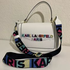 Brand New With Tags! Karl Lagerfeld Paris Crossbody Handbag. Multicolor/Rainbow Lettering With Rhinestones. One Outside Slip Pocket. Inside Has 2 Slip Pockets And 2 Card Slots. Adjustable Strap. Gold Hardware. Dust Bag Included. Processing Code, Rainbow Lettering, Karl Lagerfeld Bags, Colorful Handbags, Cell Phone Holster, Phone Holster, Vr Headset, Travel Party, Karl Lagerfeld Paris