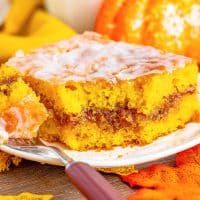 a piece of cake sitting on top of a white plate next to some oranges