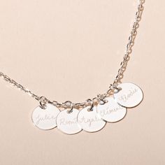 Inspired by the strong family bond, our Personalised 4 &amp; More Necklace is made up of delicate charms, all hand-engraved with the names of the ones you love. The perfect piece for those with multiple children.18K Champagne Gold Plated or 925 Sterling SilverCharm size: 1cm Diameter, 0.05cm ThicknessSecure clasp fasteningCharms are removable from this chain and can be worn on all Merci Maman chain lengthsHand engraved in our Paris workshopSent with love in a complimentary gift boxAny slight Silver Name Necklace With Charms For Anniversary, Hand Stamped Sterling Silver Necklaces In Yellow Gold, Sterling Silver Name Necklace With Charms Pendant, Engraved White Gold Round Pendant Charms, Personalized Round Sterling Silver Charms, Personalized White Gold Round Pendant Charm, Silver Nameplate Necklace With Charms, Personalized Round White Gold Charm Necklaces, Personalized White Gold Round Charm Necklaces