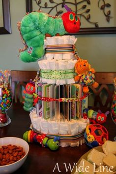 a very large stack of diapers sitting on top of a table next to some food