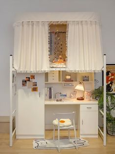 a white desk and chair in a room with a curtain on the window over it