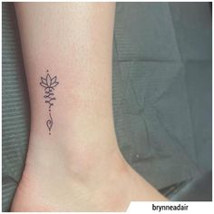 a small tattoo on the ankle of a woman