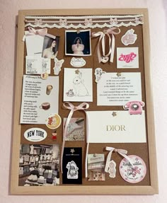 a cork board covered in pictures and magnets with ribbons on the bottom, along with other items