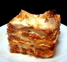 a stack of lasagna stacked on top of each other with cheese and meat toppings