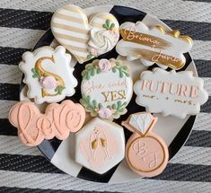 decorated cookies are on a plate with the words future mrs and mr