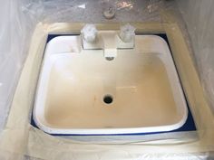 a bathroom sink in the process of being painted