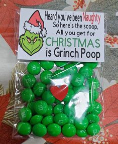 a bag filled with green candies sitting on top of a table