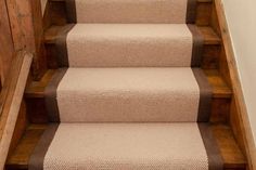 a carpeted staircase with brown and beige steps