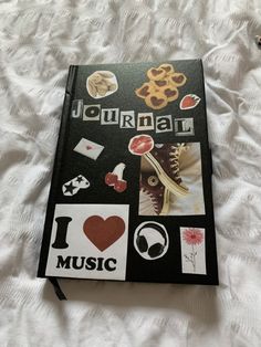 a book with stickers on it sitting on top of a bed