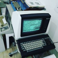 an old computer sitting on top of a desk