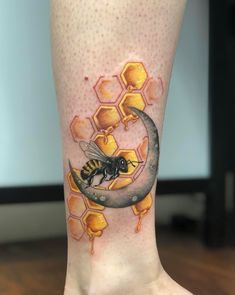 a bee sitting on the moon with honeycombs around it