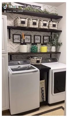 a washer and dryer in a laundry room with shelves above it that have baskets on them