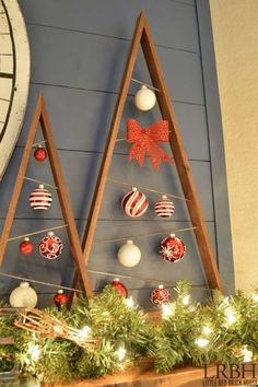 a christmas tree with ornaments hanging from it's sides in front of a clock