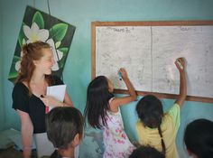 a group of children writing on a white board