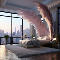 an angel wing hanging over a bed in a room with large windows overlooking the city