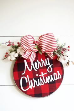 a red and black plaid christmas ornament hanging on a wall