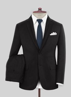 For your first good suit, the universally accepted rule among the fashionable crowd is to keep it black and our Black Merino Wool Suit would be a great addition to your wardrobe.   Merino fibres are extremely fine, enabling them to bend far more than traditional, coarser wool fibres. This makes Merino wool fabric feel soft and luxuriously gentle next to your skin.   A stylish travel-friendly fabric, great for summer nights, winter days and best for business trips.   Lining: 100% Viscose, Dry Clean. Black Single-breasted Suit For Semi-formal Occasions, Timeless Tailored Black Tuxedo, Black Single Breasted Suit For Semi-formal Occasions, Black Single-breasted Suit For Semi-formal Events, Fitted Black Three-piece Suit For Business Casual, Black Wool Tuxedo Suits, Tailored Black Wool Three-piece Suit, Black Timeless Tailored Suit, Black Slim Fit Suit In Suiting Fabric