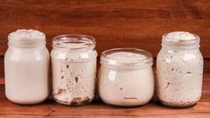 four jars with different types of food in them