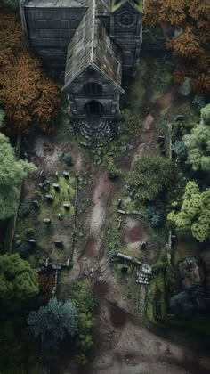 an aerial view of a building surrounded by trees and bushes in the middle of a forest