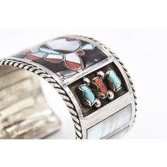 This beautiful bracelet is by Zuni artists Filbert & Clara Gasper. Circa 1960 - 1970. The bracelet is sterling silver with inlay turquoise, mother of pearl and coral. In the center is an inlaid face and on the sides there are additional bezel set turquoise and coral pieces. The next section has inlay mother of pearl rectangles. The piece has a 1" area to get your wrist into. Interior cuff length is 6.75".   Filbert and Clara Gasper are highly recognized and noted Zuni artists that are known for Turquoise And Coral, Silver Cuff Bracelet, Silver Cuff, Beautiful Bracelet, Cuff Bracelet, Mother Of Pearl, Native American, Coral, Cuff