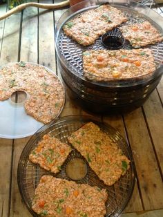 several trays of food sitting on top of a wooden table next to each other