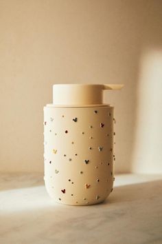 a white cup sitting on top of a counter