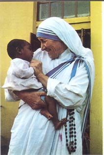 an old man holding a small child in his lap and wearing a white robe with blue trim