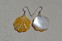 This beautiful earrings feature a carved yellow Mother of Pearl Scallop Shell. . The iridescence of the Mother of Pearl is really amazing. Depending on the light source they will radiate colors varying from yellows to creamy whites with flashes of pinks. The shells are then polished to a high gross to reveal the beauty of their natural pattern. The perfect way to complete your beach outfit and everyday wear. DETAILS - Shell types : Mother of Pearl - Material: Sterling Silver Ear Wire and Jump Ri Nickel-free Shell-shaped Earrings Gift, Sterling Silver Shell Earrings For Gift, Unique Shell-shaped Earrings For Gift, Unique Yellow Pierced Earrings, Shell-shaped Mother Of Pearl Earrings For Gift, Gift Shell-shaped Mother Of Pearl Earrings, Unique Yellow Earrings, Carved Yellow Jewelry Gift, Carved Yellow Jewelry For Gift