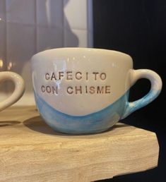 two coffee cups sitting on top of a counter