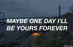 a man sitting on top of a hill next to a fire under a bridge with the words maybe one day i'll be yours forever