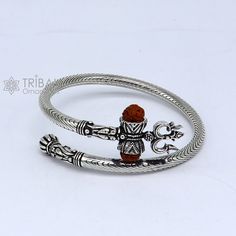 Vintage antique design handmade 925 sterling silver amazing rudraksha beads bahubali shiva trident trishool kada bangle bracelet, excellent gifting jewelry from Rajasthan india. Metal-925 Sterling silver. Item type-Bangle/Bracelet/kada Weight-35.570 grams approx. Width-5.mm bangle size size-adjustable by twisting it.(inner diameter-6.0 cm)2-6(we can easily wear bigger size like 2-8) Stamped-925. finish-Oxidized. Excellent gifting jewelry Adjustable Silver Jewelry For Puja, Symbolic Bracelet Jewelry For Puja, Silver Bangle For Puja, Symbolic Silver Jewelry For Puja, Symbolic Silver Jewelry For Festivals, Bracelet Jewelry As Navratri Gift, Symbolic Oxidized Jewelry For Festivals, Silver Bracelet Jewelry For Diwali, Bracelet Jewelry Gift For Navratri