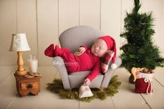 a baby is sleeping on a chair in front of a christmas tree and other decorations