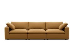 a brown couch with two pillows on it's back and one arm facing the camera