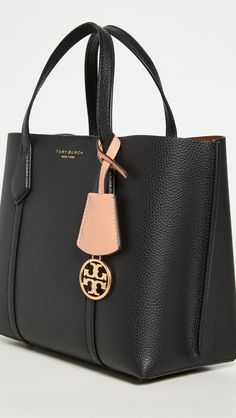 Find TORY BURCH Perry Small Triple Compartment Tote on Editorialist. Leather: Cowhide. Pebbled leather. Removable logo charm. Magnetic closure at top. Interior center zip divider pocket. Optional adjustable crossbody strap. Lined. Weight: 20oz / 0.57kg. Imported, China. Measurements: Height: 7.75in / 20cm Length: 9.5in / 24cm Depth: 4.75in / 12cm Strap drop: 22.5in / 57cm Handle drop: 4.25in / 11cm Tory Burch Perry Tote, Tory Burch Crossbody Bag, Tory Burch Crossbody, Tory Burch Tote, Tory Burch Handbags, Small Tote Bag, Black Tote, Small Tote, Black Handbags