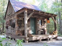 a small log cabin in the woods with lots of woodwork tools on the porch