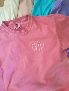 A super cute, simple and sweet shirt you just need to add to your wardrobe!  Customize this shirt with your initials.  Perfect to treat yourself, a gift for a friend, bridesmaid gifts and more!  Order this cute shirt in several colors for a great wardrobe staple! You choose your shirt color and thread color.  A soft Comfort Colors t-shirt is machine embroidered with the design in the listing photo.   Looking for a different message or color combination?  Send me a message! Follow @lehappyhive on Pink Monogram Crew Neck Top, Pink Crew Neck Top With Monogram, Pink Monogrammed Crew Neck Top, Personalized Pink T-shirt For Summer, Pink Monogram Cotton Top, Pink Monogrammed Cotton Top, Casual Personalized Pink T-shirt, Casual Personalized Pink Tops, Casual Personalized Pink Top