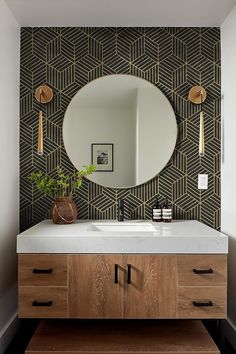 a bathroom with a mirror, sink and wooden cabinet in front of the mirror is an art deco wallpaper